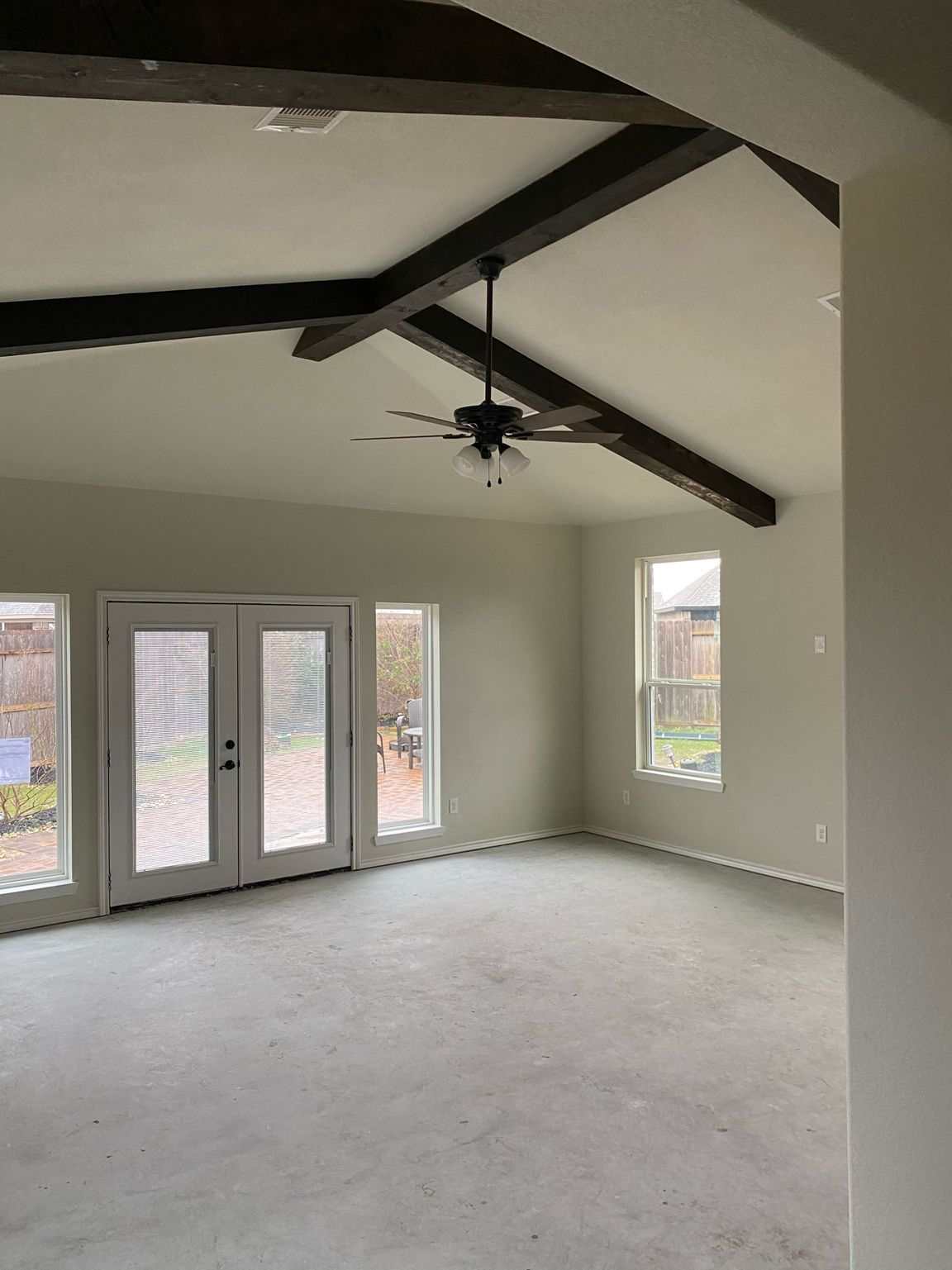 Completed room addition with exposed ceiling beams